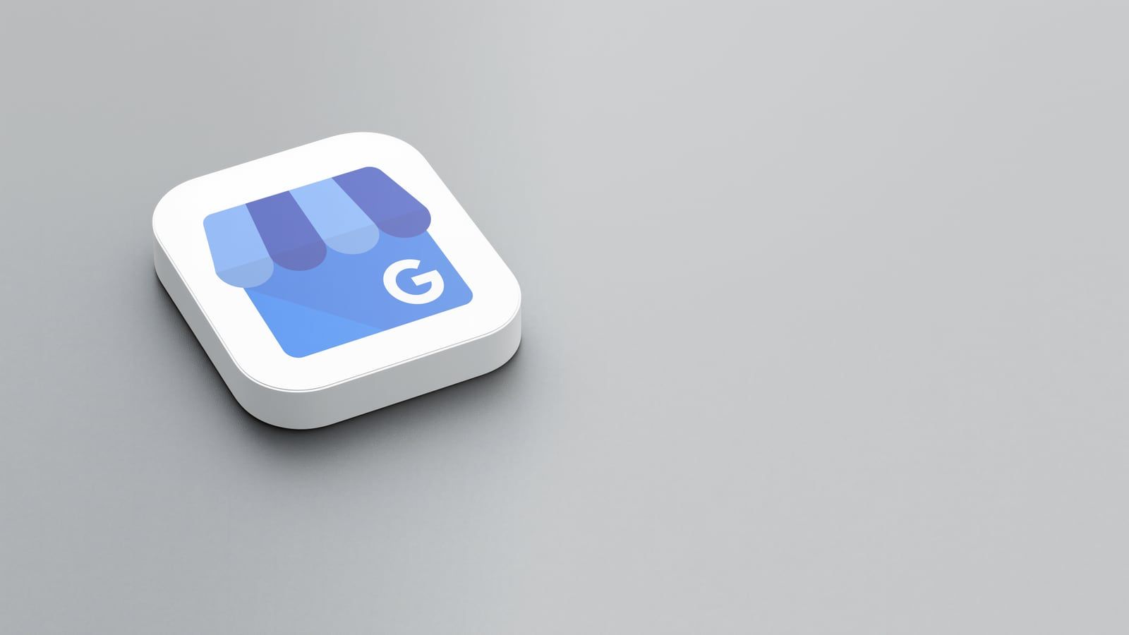 Blaues Symbol des Google-Unternehmensprofils mit Ladenmarkise und G-Logo auf grauem Hintergrund